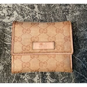 Authentic Gucci Monogram Trifold Wallet in pink and tan.